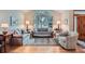 Bright living room showcasing a large arched window, comfortable seating, hardwood floors, and elegant decor at 31190 Cinnamonwood, Evergreen, CO 80439