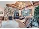 Inviting living room showcasing a stone accent wall, wood ceiling beams, and cozy seating at 31190 Cinnamonwood, Evergreen, CO 80439