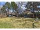 Large backyard with mature trees, a storage shed, a hammock, and plenty of space for outdoor activities at 270 S Locust St, Denver, CO 80224
