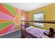 Bright bedroom features colorful sun mural, bunkbeds, and a sunny window view at 270 S Locust St, Denver, CO 80224