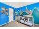 bedroom features whimsical mountain mural, crib, and Breckenridge ski poster at 270 S Locust St, Denver, CO 80224