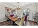 Stylish dining room features a wooden table, unique chandelier, and a decorative world map wall hanging at 270 S Locust St, Denver, CO 80224
