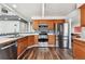 Modern kitchen with stainless steel appliances, wooden cabinets, and tiled backsplash at 270 S Locust St, Denver, CO 80224