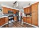 Well-equipped kitchen featuring wooden cabinetry, stainless steel appliances, and plenty of counter space at 270 S Locust St, Denver, CO 80224