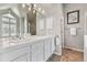 Bright main bathroom with double vanity, large mirror, and modern lighting at 270 S Locust St, Denver, CO 80224