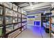 Storage room with ample storage, shelving, snowboard, and unique blue lighting at 270 S Locust St, Denver, CO 80224
