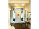 Bright foyer featuring tile flooring, natural light, and a decorative mirror on the wall at 3001 S Vine St, Denver, CO 80210