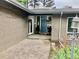 Charming front entrance with a blue door, hanging flower baskets, and brick accents at 3001 S Vine St, Denver, CO 80210