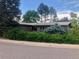 Traditional one-story house with a well-manicured yard, mature hedges, and brick exterior at 3001 S Vine St, Denver, CO 80210