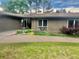 Beautiful brick home with a manicured lawn, colorful flower beds, and a charming front entrance at 3001 S Vine St, Denver, CO 80210