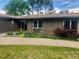 Beautiful brick home with a manicured lawn, colorful flower beds, and a charming front entrance at 3001 S Vine St, Denver, CO 80210