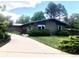 Charming one-story home with a brick exterior, mature trees, and a long driveway at 3001 S Vine St, Denver, CO 80210