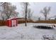 A large backyard featuring a storage shed and a trampoline at 460 Lansing St, Aurora, CO 80010