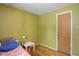 Cozy bedroom featuring wood flooring and neutral colored walls at 460 Lansing St, Aurora, CO 80010