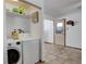 Functional laundry room with washer, dryer and tile flooring at 460 Lansing St, Aurora, CO 80010