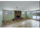 Cozy living room with stone fireplace, tile flooring, and natural light at 460 Lansing St, Aurora, CO 80010