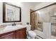 Full bathroom with tiled shower, solid surface vanity, and framed mirror at 493 Pine Flower Ct, Highlands Ranch, CO 80126