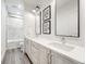 Bright bathroom with double vanity, framed mirrors, white cabinetry, and modern fixtures at 493 Pine Flower Ct, Highlands Ranch, CO 80126