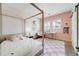 Stylish bedroom with a four-poster bed, pink accents, and abundant natural light at 493 Pine Flower Ct, Highlands Ranch, CO 80126