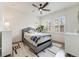 Comfortable bedroom with natural light from windows and a ceiling fan for climate control at 493 Pine Flower Ct, Highlands Ranch, CO 80126