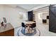 Cozy dining area with round table, modern chairs, rug, and barn door at 493 Pine Flower Ct, Highlands Ranch, CO 80126