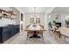 Bright dining room featuring a modern chandelier and a large wooden table at 493 Pine Flower Ct, Highlands Ranch, CO 80126