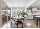 Bright dining room features hardwood floors, modern lighting, and a sliding glass door at 493 Pine Flower Ct, Highlands Ranch, CO 80126