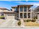 Stunning two-story home showcasing stone accents, a tile roof, and a covered front porch at 493 Pine Flower Ct, Highlands Ranch, CO 80126