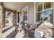Cozy front porch with stone accents, seating and views of the neighborhood at 493 Pine Flower Ct, Highlands Ranch, CO 80126
