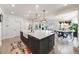 Spacious kitchen island features bar seating, farmhouse sink, and stylish pendant lighting at 493 Pine Flower Ct, Highlands Ranch, CO 80126
