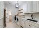 Well-equipped laundry room with a sink, ample counter space, and modern appliances at 493 Pine Flower Ct, Highlands Ranch, CO 80126