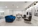 Basement living room offers blue sofa, accent chairs, and decorative wall art at 493 Pine Flower Ct, Highlands Ranch, CO 80126