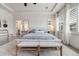 Bright and stylish main bedroom with a tray ceiling, natural light, and comfortable seating at 493 Pine Flower Ct, Highlands Ranch, CO 80126