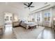 Bright main bedroom boasts tray ceilings, a ceiling fan, and large windows with neighborhood views at 493 Pine Flower Ct, Highlands Ranch, CO 80126