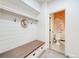 Mud room with bench seat, storage and half bath at 493 Pine Flower Ct, Highlands Ranch, CO 80126