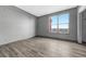 Well-lit bedroom with wood-style flooring and a large window offering a view of the neighborhood at 14333 E 1St Dr # 307, Aurora, CO 80011