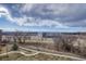 View of the community and walking trails near the building with mountain views in the distance at 14333 E 1St Dr # 307, Aurora, CO 80011