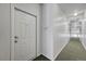 Hallway leading to unit 307, showing neutral carpeting and wall color; a secure and private entry at 14333 E 1St Dr # 307, Aurora, CO 80011