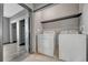 A functional laundry room with washer, dryer and shelving at 14333 E 1St Dr # 307, Aurora, CO 80011