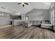 Open-concept living area with hardwood floors, a comfortable sofa, and seamless flow to the kitchen at 14333 E 1St Dr # 307, Aurora, CO 80011