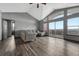 Inviting living room with stylish gray walls, wood-look flooring, large windows, and cozy sectional sofa at 14333 E 1St Dr # 307, Aurora, CO 80011