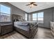 Cozy main bedroom showcasing a large bed, wood-style floors, and abundant natural light from the large windows at 14333 E 1St Dr # 307, Aurora, CO 80011