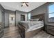 Main bedroom with a large bed, wood-style floors, and ensuite bathroom at 14333 E 1St Dr # 307, Aurora, CO 80011