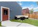 Inviting backyard with artificial turf, fire pit, and patio at 12740 Tamarac St, Thornton, CO 80602