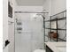 Modern bathroom showcasing an enclosed shower and stylish shelving at 12740 Tamarac St, Thornton, CO 80602