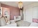 Cozy Bedroom with crib, chair, and a decorative wall accent at 12740 Tamarac St, Thornton, CO 80602