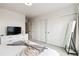 Bright bedroom featuring a comfortable bed, television, and slider door closets at 12740 Tamarac St, Thornton, CO 80602