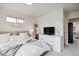 Inviting bedroom features a comfortable bed and a dresser with a television at 12740 Tamarac St, Thornton, CO 80602