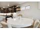 Stylish dining area with white round table, dark cabinets, and modern decor at 12740 Tamarac St, Thornton, CO 80602