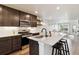 Open-concept kitchen with island seating flows seamlessly into the living area at 12740 Tamarac St, Thornton, CO 80602